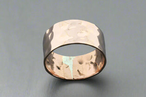 Hammered copper ring on a gray background
