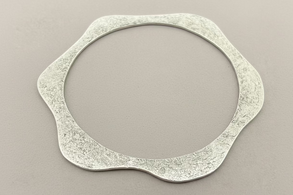 Curved and textured disc bangle - sterling silver