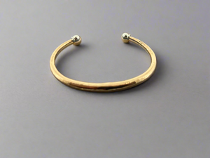 Bronze bracelet with silver beads on a dark gray background
