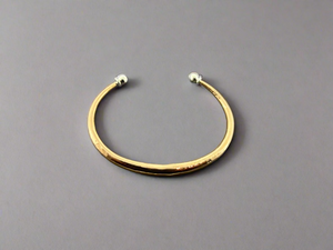 Bronze bracelet on a dark gray background
