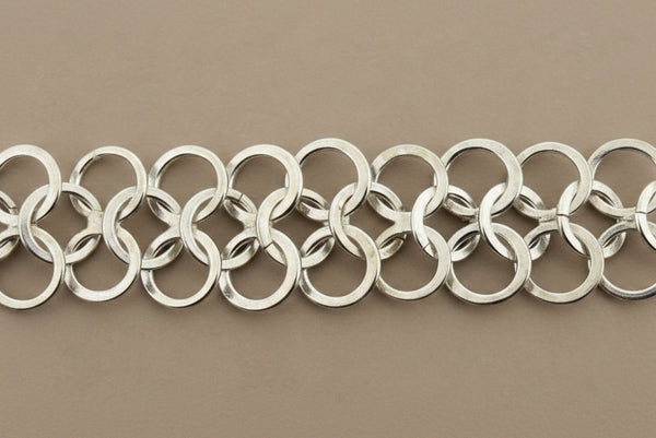 Close-up of a silver chain on a dark gray background