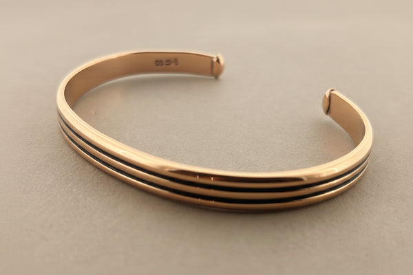 Bronze bangle on a gray background