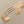 Load image into Gallery viewer, Rose gold bracelet on a gray background

