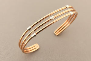 Rose gold bracelet on a gray background