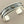 Load image into Gallery viewer, Silver bracelet with a gold accent on a dark gray background
