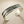 Load image into Gallery viewer, Silver bracelet with a central gold bead on a dark gray background
