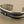 Load image into Gallery viewer, Silver bracelet with a central gold bead on a gray background

