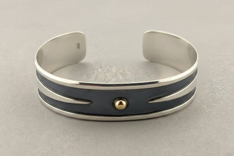 Silver bracelet with blue accents on a gray background