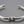 Load image into Gallery viewer, Silver knot bracelet on a gray background
