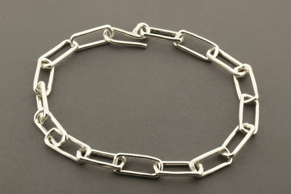 Silver chain bracelet on a gray background