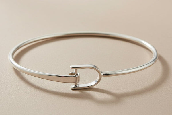 Silver bangle on a gray background