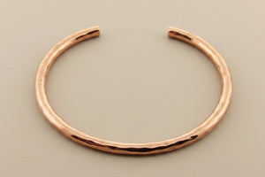 Copper bracelet on a gray background