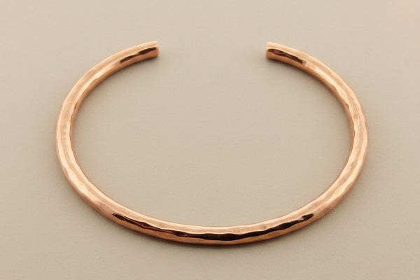 Copper bracelet on a gray background