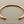 Load image into Gallery viewer, Rose gold bracelet on a gray background
