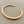 Load image into Gallery viewer, Rose gold bracelet on a gray background
