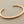 Load image into Gallery viewer, Rose gold bangle on a gray background
