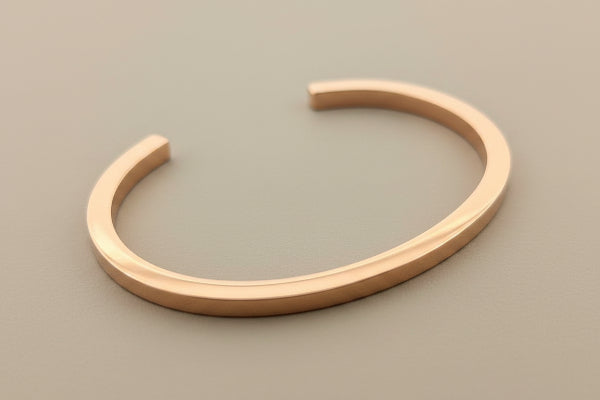 Rose gold bangle on a gray background