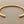 Load image into Gallery viewer, Rose gold bracelet on a gray background
