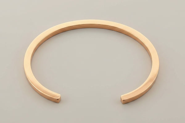 copper bracelet on a gray background
