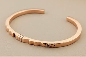 copper bracelet on a gray background