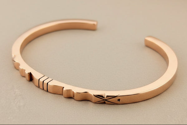 copper bracelet on a gray background