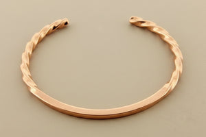 copper bracelet on a dark gray background