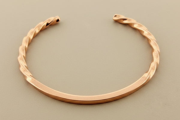 copper bracelet on a dark gray background