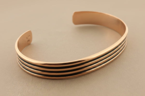 copper bangle on a gray background
