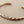 Load image into Gallery viewer, Twisted rose gold and silver bracelet on a gray background
