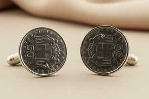 Pair of coin cufflinks on a gray background