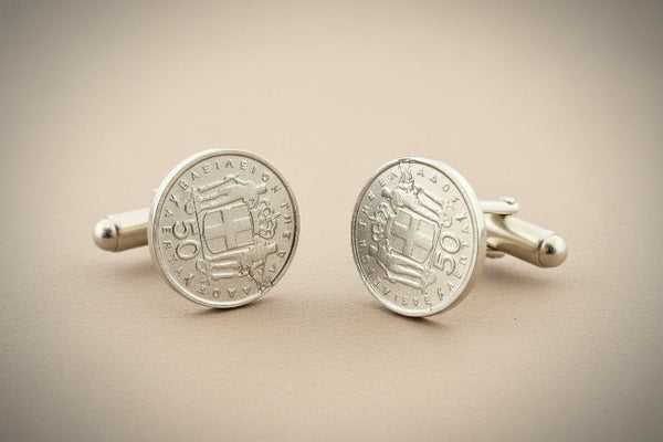 Pair of silver coin cufflinks on a gray background