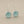 Load image into Gallery viewer, A pair of silver drop earrings with round, light blue sea glass disc pendants, displayed on a dark gray textured background.
