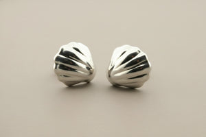 Pair of silver earrings on a gray background