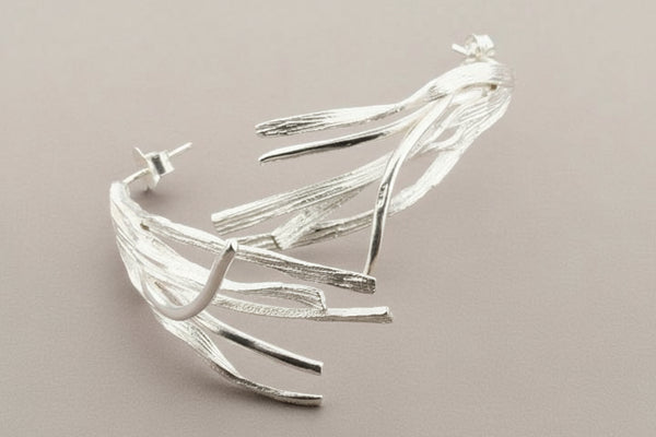 Silver bracelet on a dark gray background
