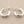 Load image into Gallery viewer, Pair of silver hoop earrings on a gray background
