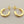 Load image into Gallery viewer, Gold hoop earrings on a gray background
