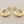 Load image into Gallery viewer, Gold hoop earrings on a gray background
