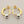 Load image into Gallery viewer, Gold hoop earrings with silver caps on a gray background

