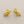 Load image into Gallery viewer, Pair of gold earrings on a gray background
