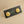 Load image into Gallery viewer, Gold floral earrings on a black card with &#39;Akerov&#39; branding against a gray background

