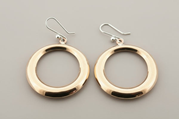 Copper hoop earrings on a gray background