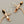 Load image into Gallery viewer, Pair of copper dragonfly earrings on a gray background
