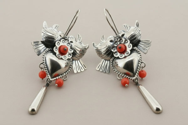 Pair of silver earrings on a gray background