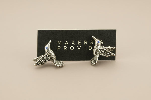 Silver bird-shaped earrings on a card with 'Makers & Providers' branding.