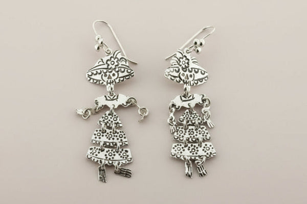 Pair of silver earrings on a dark gray background