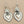 Load image into Gallery viewer, Silver heart-shaped earrings on a dark gray background
