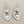 Load image into Gallery viewer, Silver heart-shaped earrings on a dark gray background
