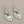 Load image into Gallery viewer, Silver heart-shaped earrings on a dark gray background
