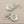 Load image into Gallery viewer, Pair of silver earrings on a dark gray background
