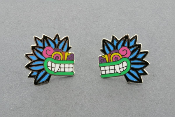 Pair of colorful mask-shaped earrings on a gray background